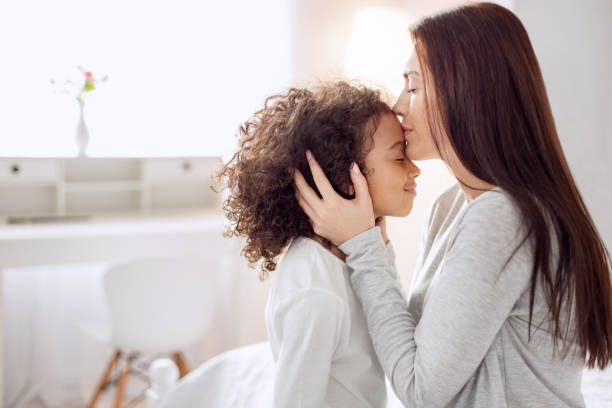 istock Inspired mother kissing her daughter 930549158