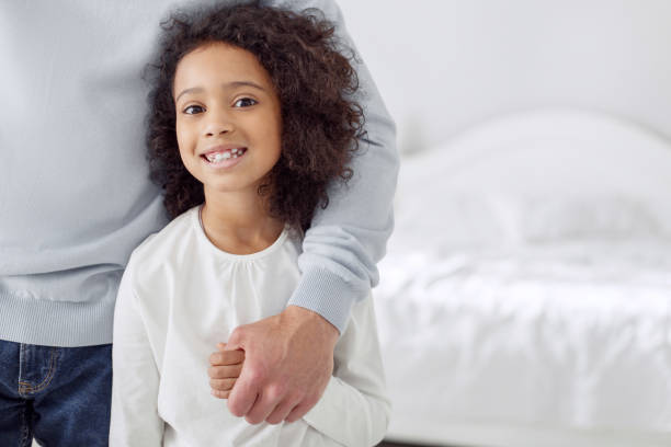 istock Delighted girl standing near her dad 930549376