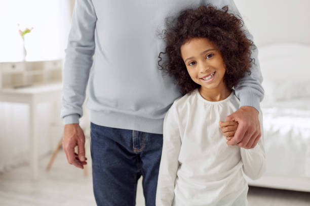 istock Cheerful girl standing near her dad 930549382