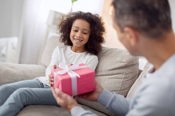 istock Loving father holding a gift for his daughter 930549638