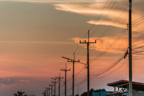 istock silhouette electric pole and sunset time 930555072
