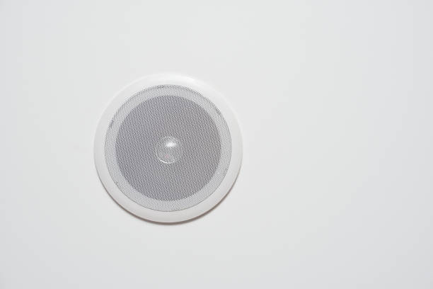 A white speaker built into the wall or the ceiling is white stock photo