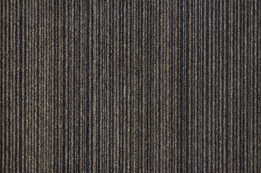 Texture of floor covering carpet, brown in stripes.