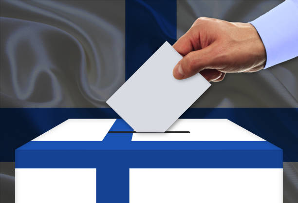 Man voting on elections in Finland front of flag stock photo