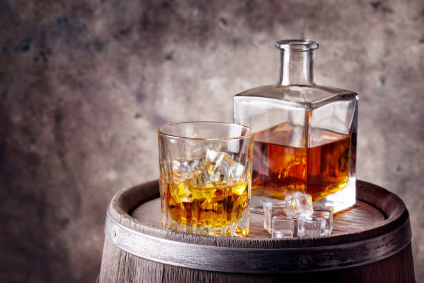 istock Whiskey with ice on wooden barrel 930574566