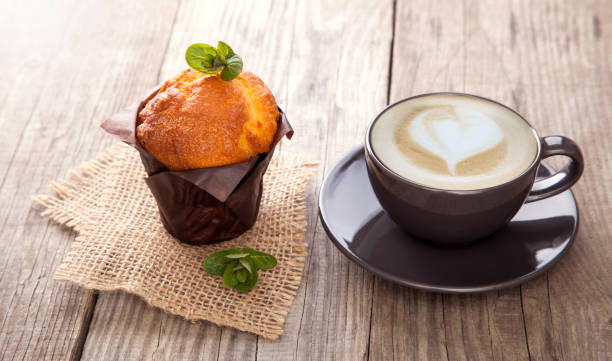istock Chocolate muffins mint and coffee on wooden table 930575802