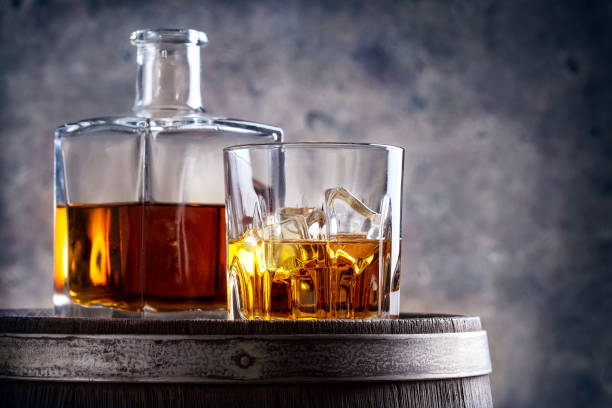 istock Glass and decanter of whiskey on barrel 930581790