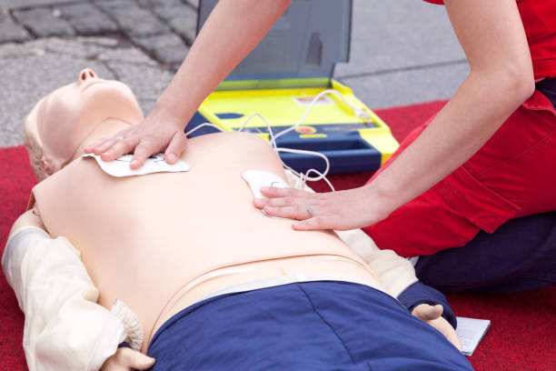 CPR course using automated external defibrillator device - AED First aid training using automated external defibrillator device - AED defibrillator photos stock pictures, royalty-free photos & images