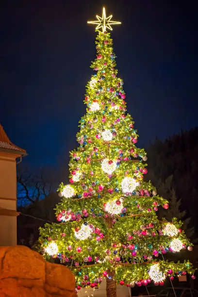 Huge Christmas Tree with lights and decorations outside on a street in Karpacz resort town, Poland