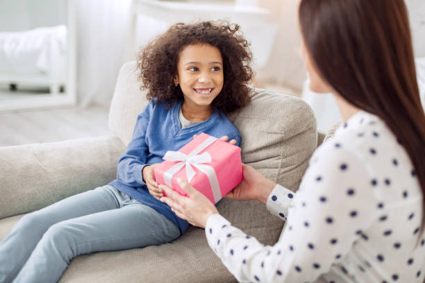 istock Loving mother giving her daughter a gift 930584974