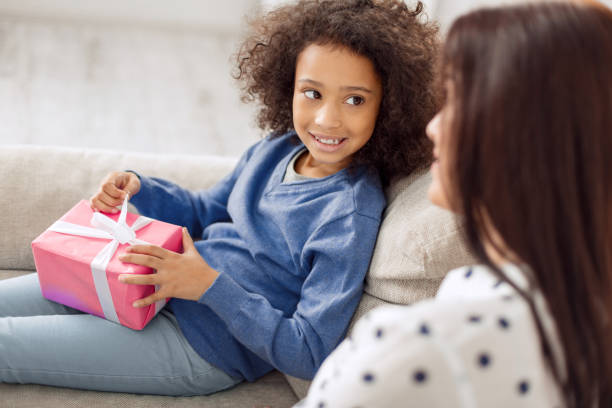 istock Delighted little girl holding her gift 930585070