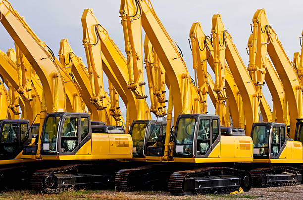 istock Rows of yellow excavators finished working for the day 93058591