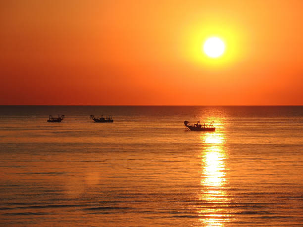 istock Fishing boats pull their nets at the sunrise. Adriatic cost. Emilia Romagna. Italy 930587906