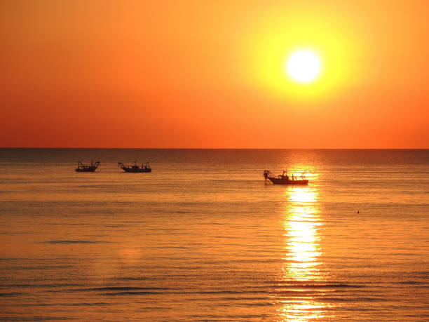 istock Fishing boats pull their nets at the sunrise. Adriatic cost. Emilia Romagna. Italy 930587974