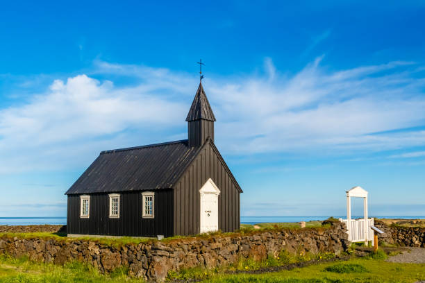 istock Budakirkja black painted Lutheran parish erected in 1847 with blue sky and clouds in the background, Snaefellsnes Peninsula, West Iceland 930591274