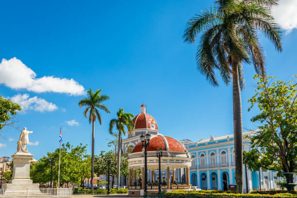 Cienfuegos Jose Marti central park with palms and historical buildings, Cienfuegos Province, Cuba Cienfuegos Jose Marti central park with palms and historical buildings, Cienfuegos Province, Cuba historic building photos stock pictures, royalty-free photos & images