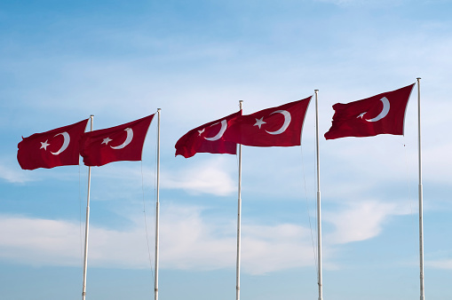 Turkey national flag waving in the wind on a clear day. Red flag with white crescent and a star. 3D illustration render. Fluttering fabric