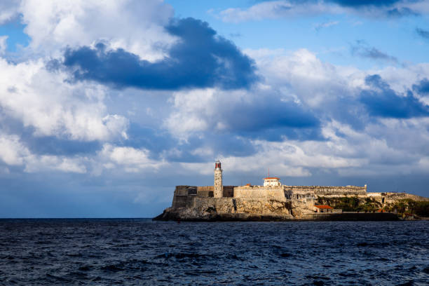 El Morro Spanish fortress walls with lighthouse with sea in the foreground and clouds above, Havana, Cuba El Morro Spanish fortress walls with lighthouse with sea in the foreground and clouds above, Havana, Cuba morro castle havana stock pictures, royalty-free photos & images