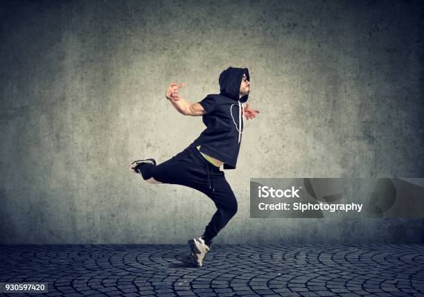 Young Man Break Dancing On Wall Background Stock Photo - Download Image Now - Dancing, Street, Dancer