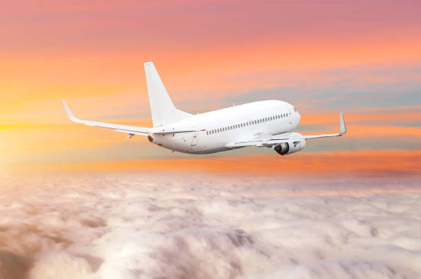 istock Passanger airplane above the clouds horizon sky with bright sunset colors. 930597512