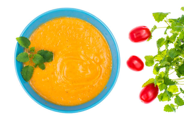 Lentil cream soup with fresh mint, top view. Studio Photo