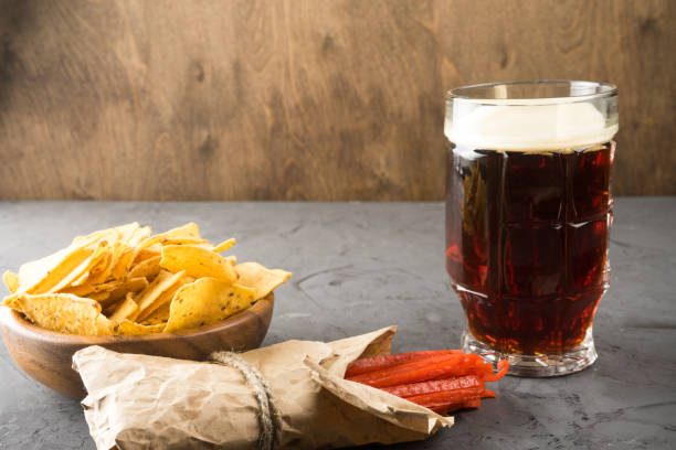 istock Dark beer, nachos and fish chips are on the table. Copy space 930597926