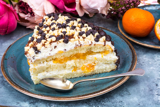 istock Delicious piece of cake with fruit, whipped cream and chocolate drops 930598556