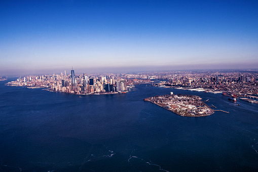 Aerial view of New York City skyline through helicopter in New York City, NY, USA. Horizontal composition. Image taken with Nikon D800 and developed from Raw format.