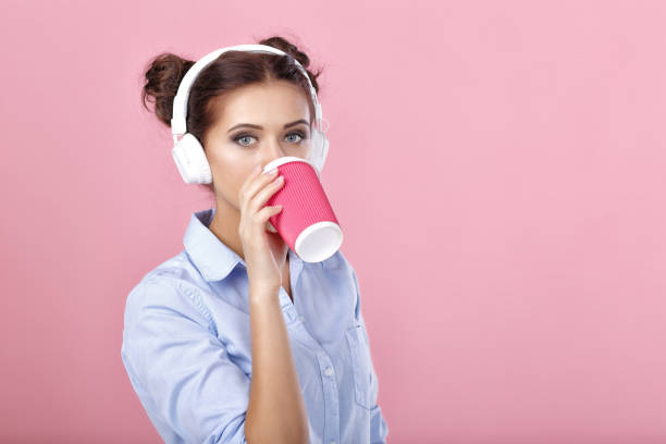 istock woman in headphones drinking coffee 930604004