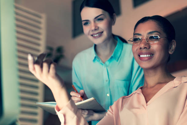 istock Charming woman taking notes of her boss remarks 930604572