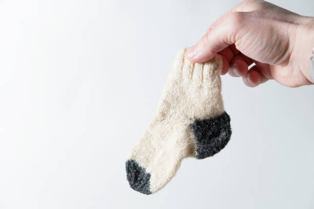istock child's wool sock in hand on a white background 930605370