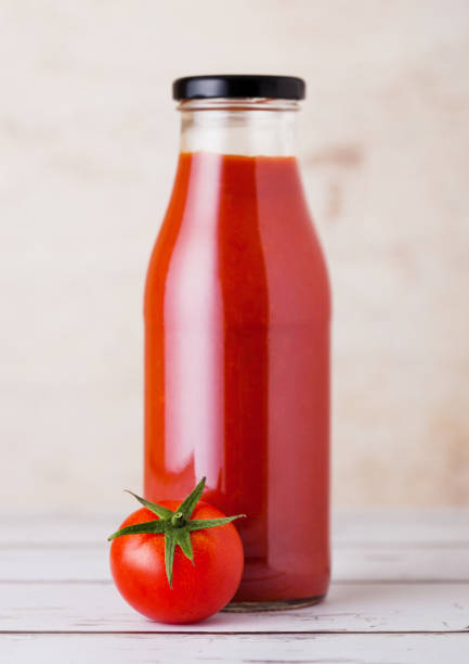 istock Glass bottle of tomato paste with raw  tomato 930609052