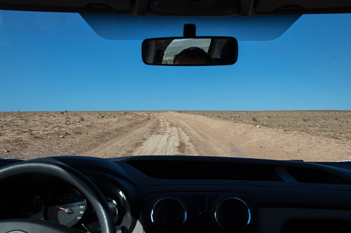 Driving through sand and dirt in a desert