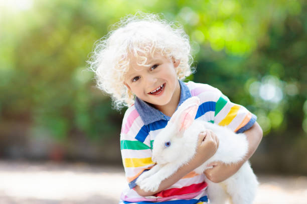 istock Child with rabbit. Easter bunny. Kids and pets. 930612652