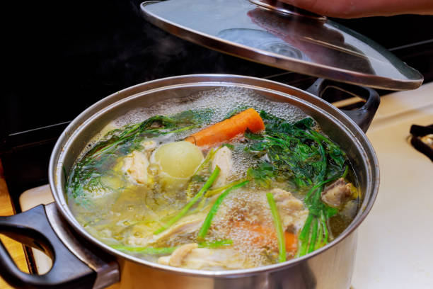 istock Ingredients for preparing chicken bone broth in a pot chicken, onions, celery root, carrots, parsley 930612786