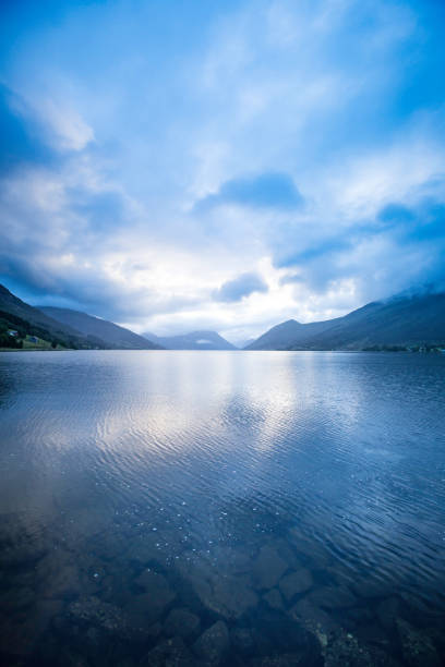 norwegische fjorde - mountain peak norway reflection sunlight stock-fotos und bilder