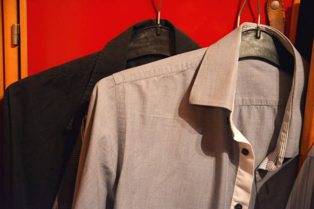 istock White shirt and black hanging in room 930620340