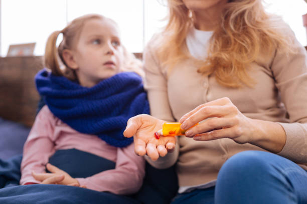 istock Sad little sick girl taking pills 930623074