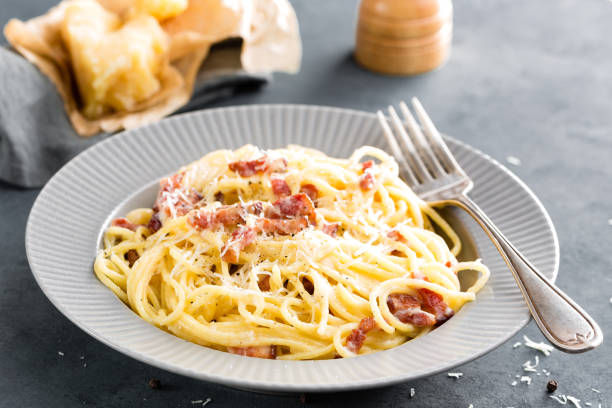 istock Carbonara pasta, spaghetti with pancetta, egg, hard parmesan cheese and cream sauce. Traditional italian cuisine. Pasta alla carbonara 930626352