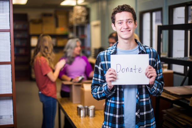 istock Volunteer Holding a Sign 930637254