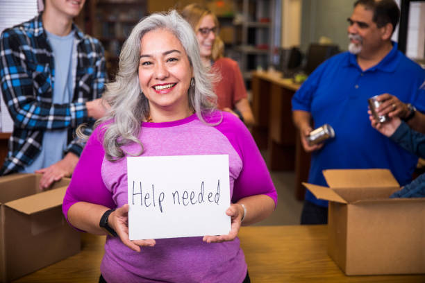 istock Volunteer Holding a Sign 930637318
