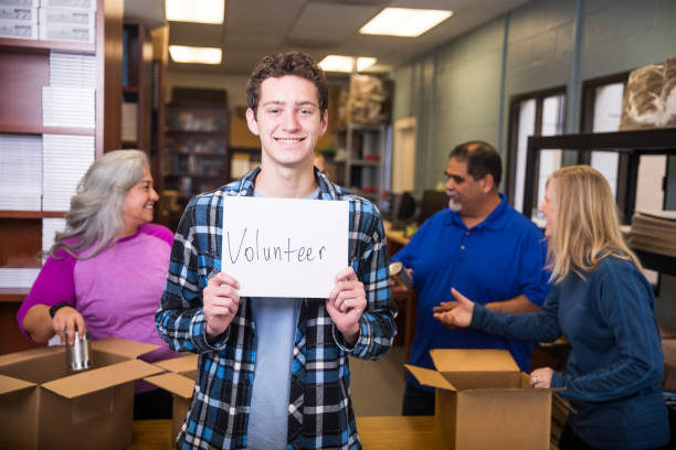 istock Volunteer Holding a Sign 930637346