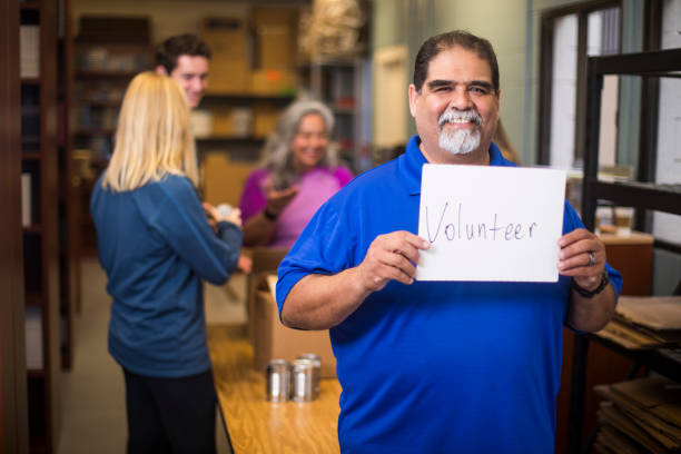 istock Volunteer Holding a Sign 930637408