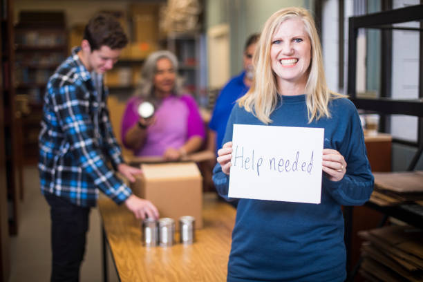 istock Volunteer Holding a Sign 930637420