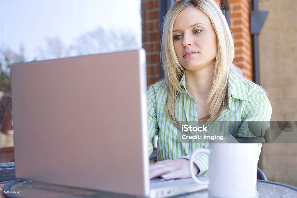 Business Woman sitting at a cafe working  Adult Stock Photo