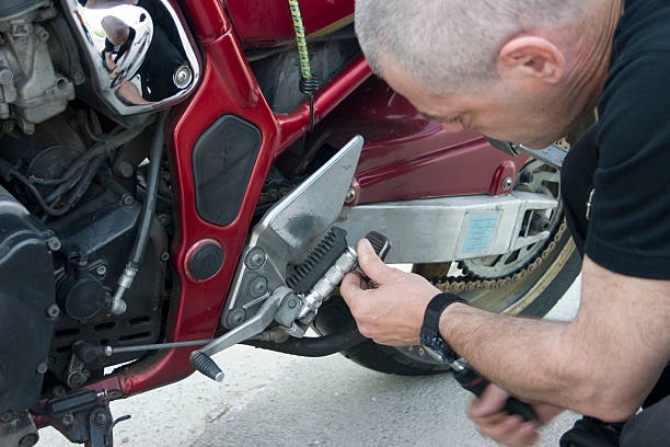 istock Man repairing red motorcycle bike 93065640