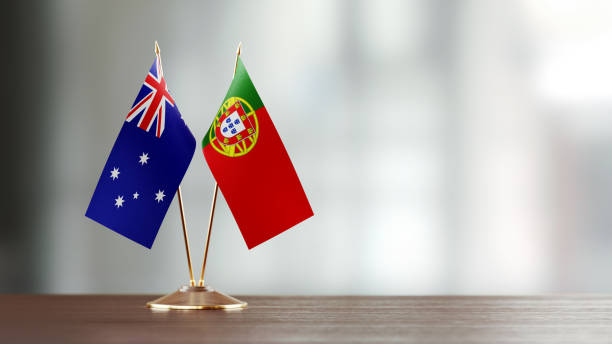 istock Australian And Portuguese Flag Pair On A Desk Over Defocused Background 930657370