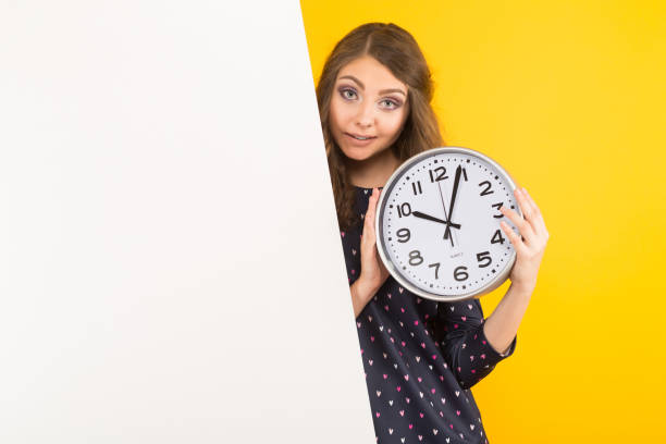 istock Brunette woman with clocks and blank banner 930658110