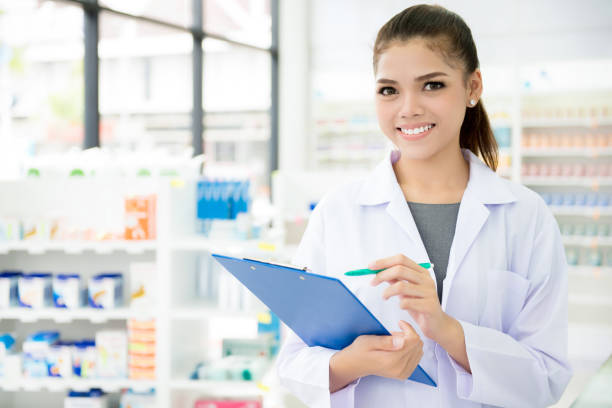 istock Asian female pharmacist working in chemist shop or pharmacy 930658598