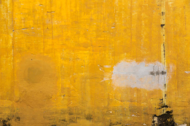 istock old yellow color concrete wall with stain and crack 930666310